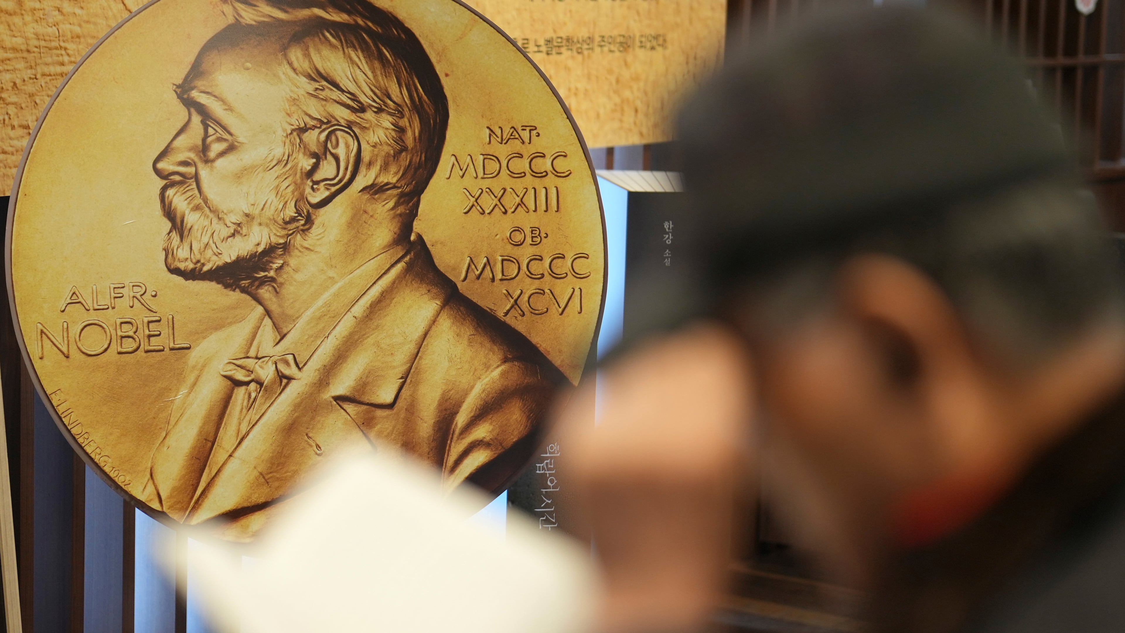 FILE - A visitor reads a book written by South Korean author Han Kang, this year's winner of the Nobel Prize in Literature, at a special section of a bookstore in Seoul, South Korea, Tuesday, Dec. 10, 2024. (AP Photo/Lee Jin-man, File)