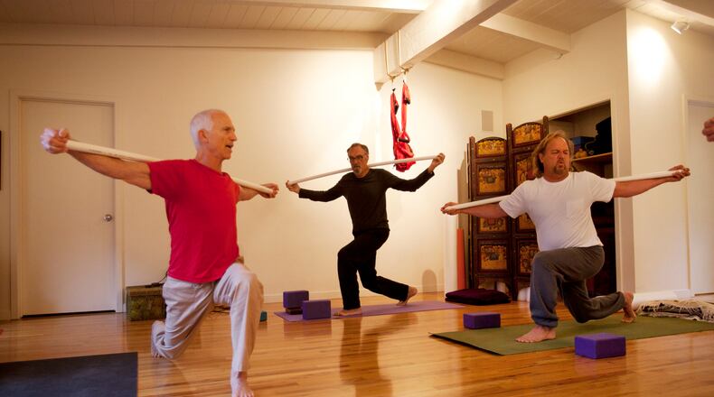 Paul Gould, left, teaches a yoga class at Namastay Yoga in Felton, Calif. Gould has a weekly class where he teaches a group of several men -- regulars who've become friends, including Jim Scheer, center, and Jon Troutner, right. (Patrick Tehan/Bay Area News Group/TNS)