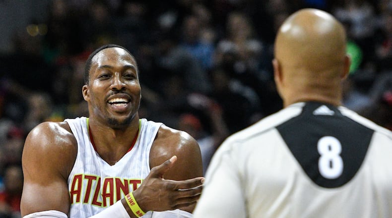 Atlanta Hawks center Dwight Howard argues with referee Marc Davis (8) about a foul called on him during the second half of an NBA basketball game against the Portland Trail Blazers, Saturday, March 18, 2017, in Atlanta. Portland won 113-97. (AP Photo/John Amis)