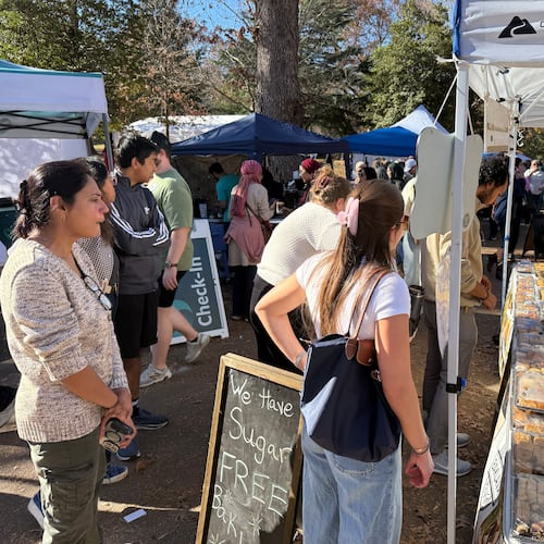 In this photo, Shiraz Taslaq, right, serves pastries from his Lawrenceville-based wholesale pastry business, Baklava, to customers at the the Atlanta Halal Fall Festival. The festival opened at noon Saturday and Sunday under a bright blue sky in Grant Park near downtown Atlanta, in what organizers hope will become a city tradition.
A brisk crowd sampled pastries, meat sandwiches, coffees, and desserts from Muslim traditions across the globe, and shopped for jewelry and crafts. Photos show the festival on Sunday, November 23, 2025 in Grant Park in Atlanta. Photo by Ariel Hart ahart@ajc.com.