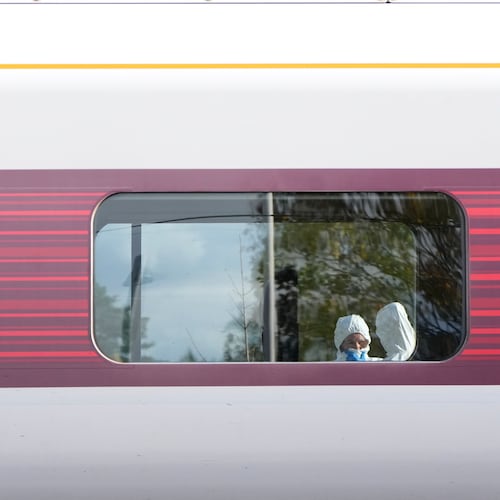 Forensic investigators are seen at the train after a mass stabbing on a London-bound train in Huntingdon, England, Sunday, Nov. 2, 2025.(AP Photo/Kirsty Wigglesworth)