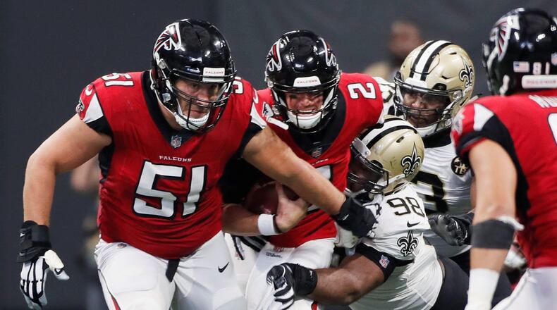 Falcons center Alex Mack (51) tries to block for quarterback Matt Ryan.  BOB ANDRES  /BANDRES@AJC.COM