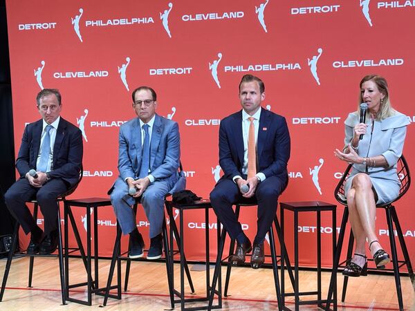 Josh Harris, left, managing partner of the Philadelphia 76ers, Arn Tellem, Detroit Pistons vice chairman, Nic Barlage, representing the Cleveland Cavaliers, listen as WNBA commissioner Cathy Engelbert speaks during a news conference, Monday, June 30, 2025, in New York, announcing WNBA basketball expansion teams in Philadelphia, Detroit and Cleveland. (AP Photo/Doug Feinberg)