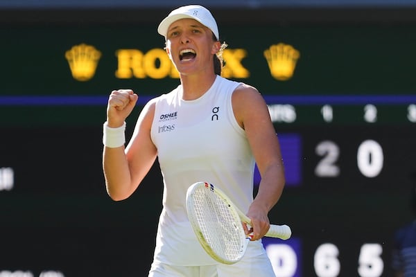 Iga Swiatek of Poland celebrates winning the women's singles semifinal match against Belinda Bencic of Switzerland at the Wimbledon Tennis Championships in London, Thursday, July 10, 2025.(AP Photo/Kirsty Wigglesworth)