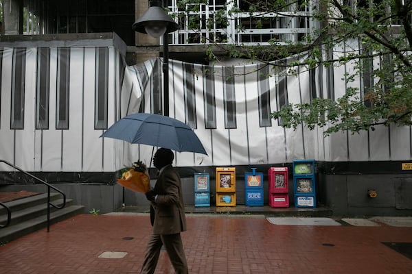 The mural wrap placed over John Dewberry's undeveloped property in Charlottesville, Virginia, in 2022 was supposed to stay for 14 to 16 months. It still remains more than four years later. (Kirsten Luce for the AJC)
