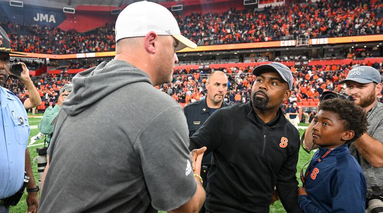 Georgia Tech coach Brent Key, left, congratulates Syracuse coach Fran Brown after a game Saturday, Sept. 7, 2024 in Syracuse, N.Y. Syracuse won 31-28. (AP Photo/Hans Pennink)