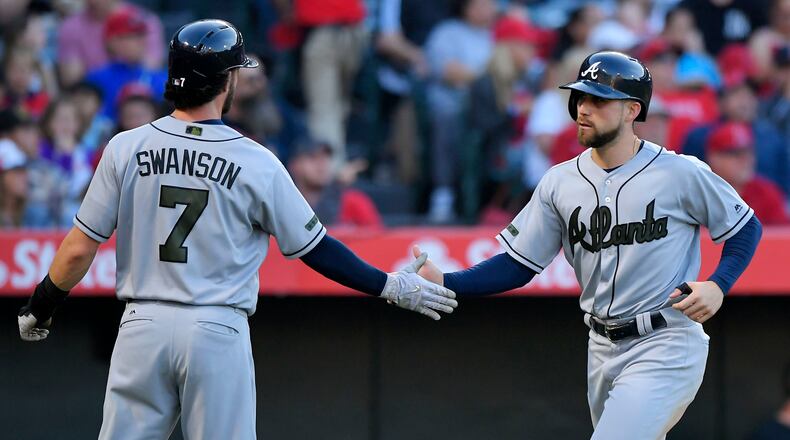 Atlanta Braves’ Dansby Swanson (left) and Ender Inciarte congratulate each other after they scored on a ground-rule double by Matt Adams during the third inning against the Los Angeles Angels, Monday, May 29, 2017, in Anaheim, Calif. (AP Photo/Mark J. Terrill)