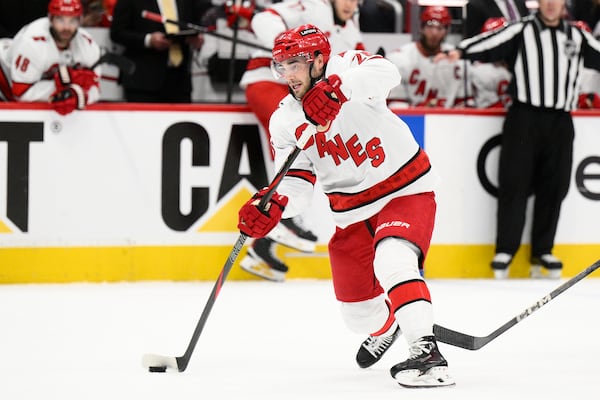 Carolina Hurricanes defenseman Sean Walker (26) takes a shot in the second period of Game 1 of a second-round NHL hockey playoff series against the Washington Capitals Tuesday, May 6, 2025, in Washington. (AP Photo/Nick Wass)