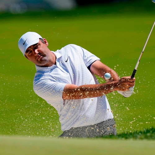 Scottie Scheffler hits from the bunker on the third green during a PGA Championship golf tournament practice round at Aronimink Golf Club, Tuesday, May 12, 2026, in Newtown Square, PA. (AP Photo/Carolyn Kaster)