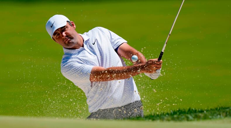Scottie Scheffler hits from the bunker on the third green during a PGA Championship golf tournament practice round at Aronimink Golf Club, Tuesday, May 12, 2026, in Newtown Square, PA. (AP Photo/Carolyn Kaster)
