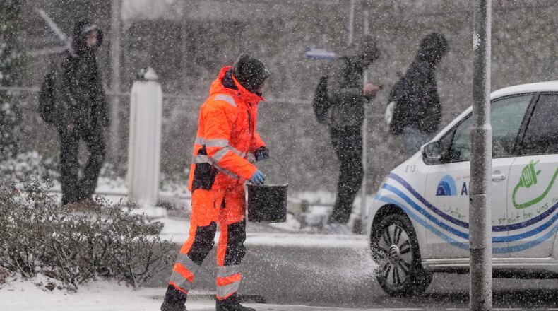 FILE - Salt is spread on a street in Gelsenkirchen, Germany, Jan. 7, 2026. (AP Photo/Martin Meissner, File)