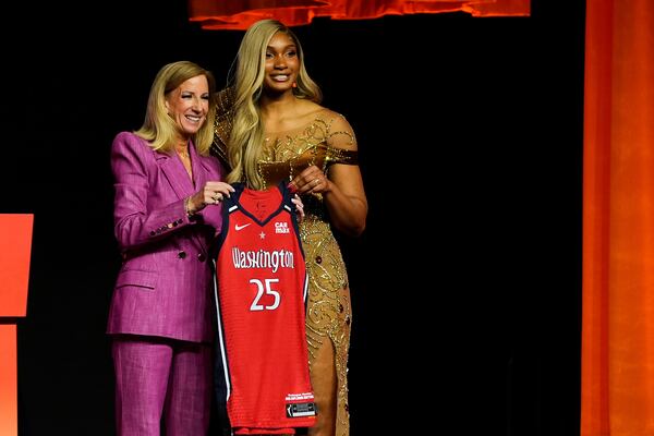 Southern California's Kiki Iriafen, right, poses with WNBA commissioner Cathy Engelbert after being selected fourth overall by the Washington Mystics during the first round of the WNBA basketball draft, Monday, April 14, 2025, in New York. (AP Photo/Pamela Smith)