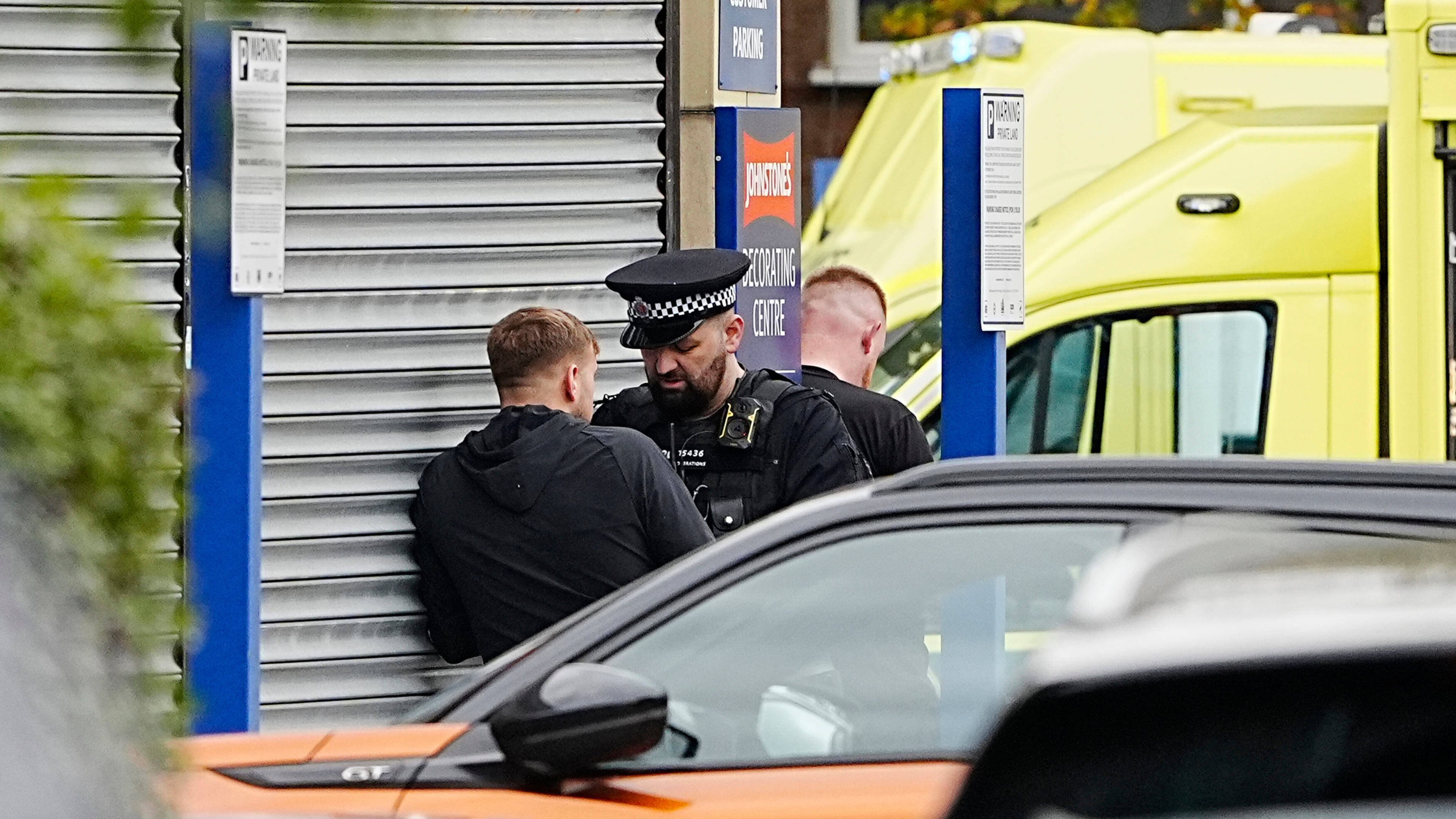 A police officer speaks to a member of the public at the scene of a stabbing at Heaton Park Hebrew Congregation synagogue, in Crumpsall, Manchester, England, Thursday Oct. 2, 2025. (Peter Byrne/PA via AP)