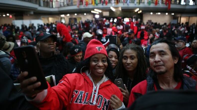 Fans take selfies at the Atlanta Falcons pep rally at City Hall on Friday. HENRY TAYLOR / HENRY.TAYLOR@AJC.COM