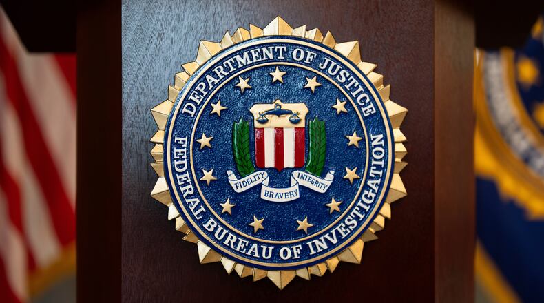 FILE - An FBI seal is displayed on a podium before a news conference at the field office in Portland, Ore., Jan. 16, 2025. (AP Photo/Jenny Kane, File)