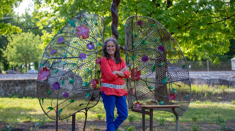 Shannon Willow stands with her sculpture, Lungs of Mother Earth, at a pocket park in Scottdale. The public art is an early element of the Compassion Corridor, a path stretching from Decatur to Stone Mountain. (Courtesy of Isadora Pennington)