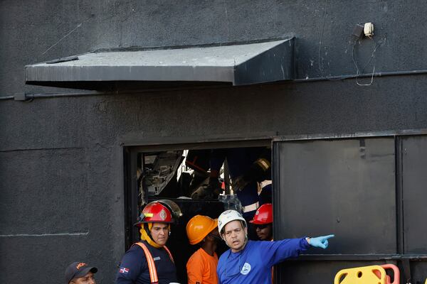 Rescue workers search for survivors at the Jet Set nightclub after its roof collapsed during a merengue concert in Santo Domingo, Dominican Republic, Tuesday, April 8, 2025. (AP Photo/Eddy Vittini)