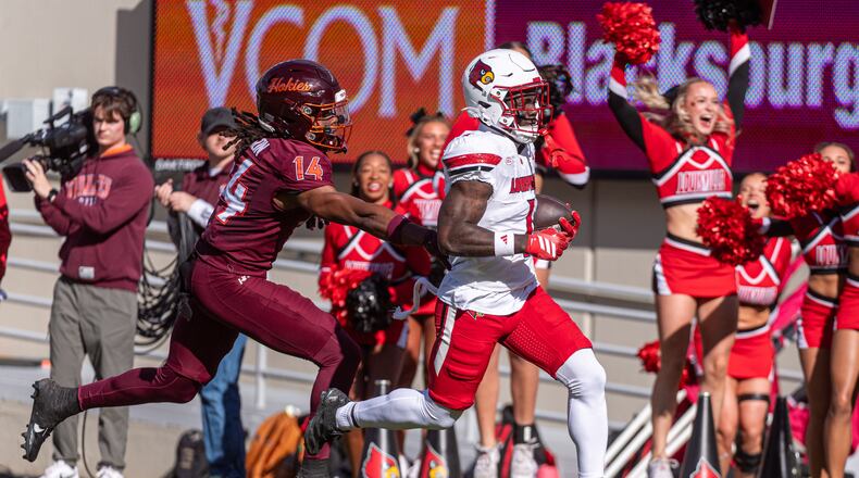 Louisville running back Isaac Brown (1) runs downfield against Virginia Tech during the first half of an NCAA college football game, Saturday, Nov. 1, 2025, in Blacksburg, Va. (AP Photo/Robert Simmons)