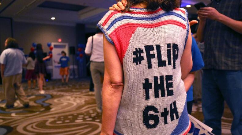 A supporter of Jon Ossoff wears a sweater she made with the "Flip the Sixth" slogan to his election-night watch party, June 20. (AJC Photo / Jason Getz)