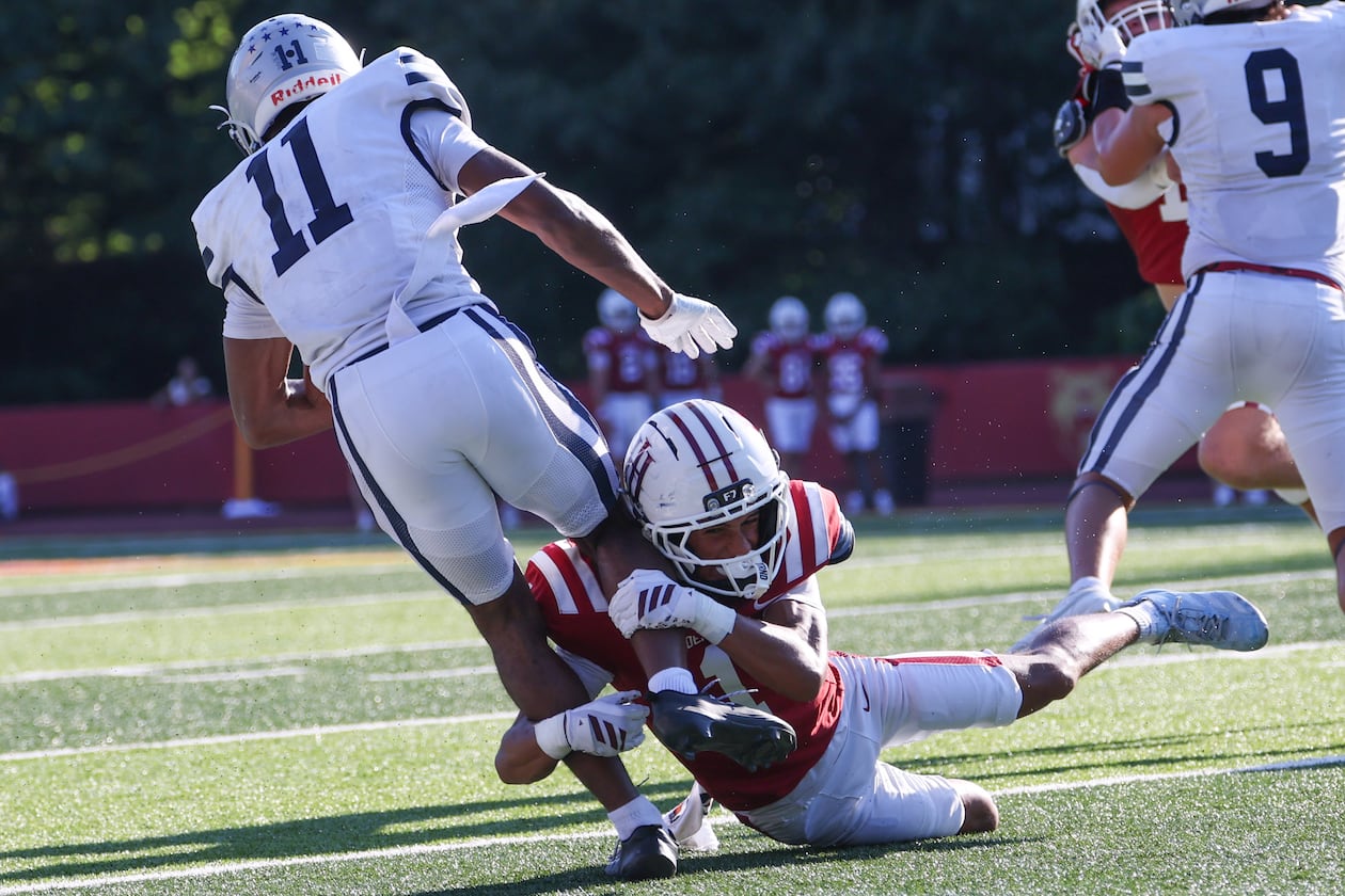 Holy Innocents' cornerback Brayden Bailey, who is the son of UGA great Champ Bailey, tackles Mount Vernon wide receiver Taurean Rawlins (left), who is committed to Georgia, in the second half of the Mount Vernon vs. Holy Innocents' high school football game at Holy Innocents' Episcopal School in Atlanta on Sept. 4, 2026. Holy Innocents' won 51-14. (Arvin Temkar/AJC)