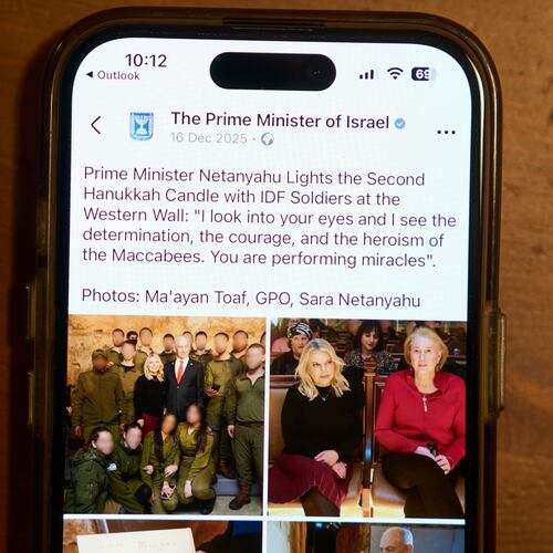 A Facebook post of the Prime Minister of Israel with a retouched photo of the Prime Minister’s wife, Sara Netanyahu, is displayed on a phone in Ramat Gan, Israel, Jan, 9, 2026 (AP Photo/Oded Balilty)
