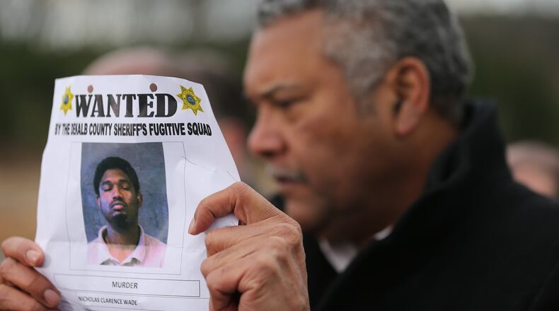 DeKalb County Sheriff Thomas Brown holds a wanted poster of the suspect as he talks to the media Wednesday afternoon.A man suspected of killing a toddler was shot by a DeKalb County deputy Wednesday afternoon in the parking lot of New Birth Missionary Baptist Church in Lithonia. According to Lt. Kyle Jones with the DeKalb County Sheriff’s Office, deputies were pursuing Nicholas Clarence Wade on a murder warrant.