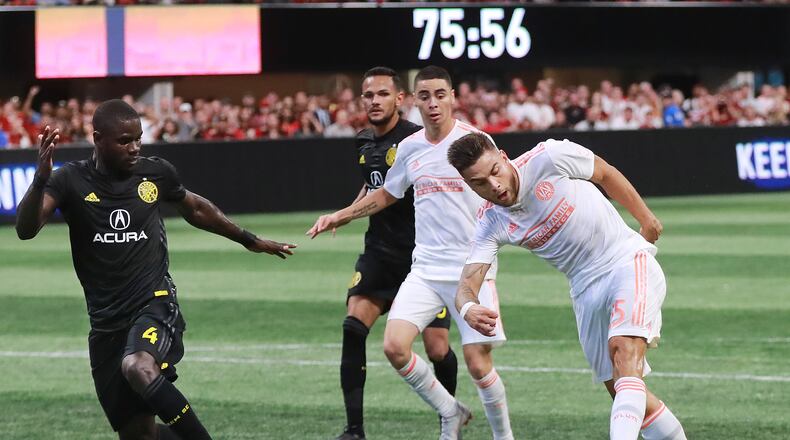 August 19, 2018 Atlanta: Atlanta United midfielder Hector Villalba scores a goal past Columbus Crew defender Jonathan Mensah for a 2-1 lead during the second half in a MLS soccer match on Sunday, August 19, 2018, in Atlanta. Curtis Compton/ccompton@ajc.com