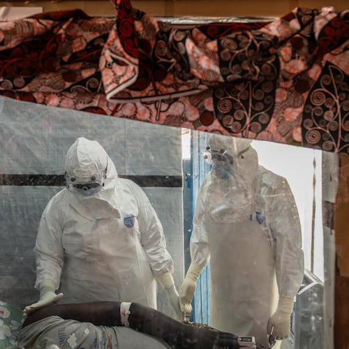 FILE - Health workers tend to an Ebola patient at the Rwampara Treatment Center in Ituri, Congo, Thursday, June 18, 2026. (AP Photo/Moses Sawasawa, file)