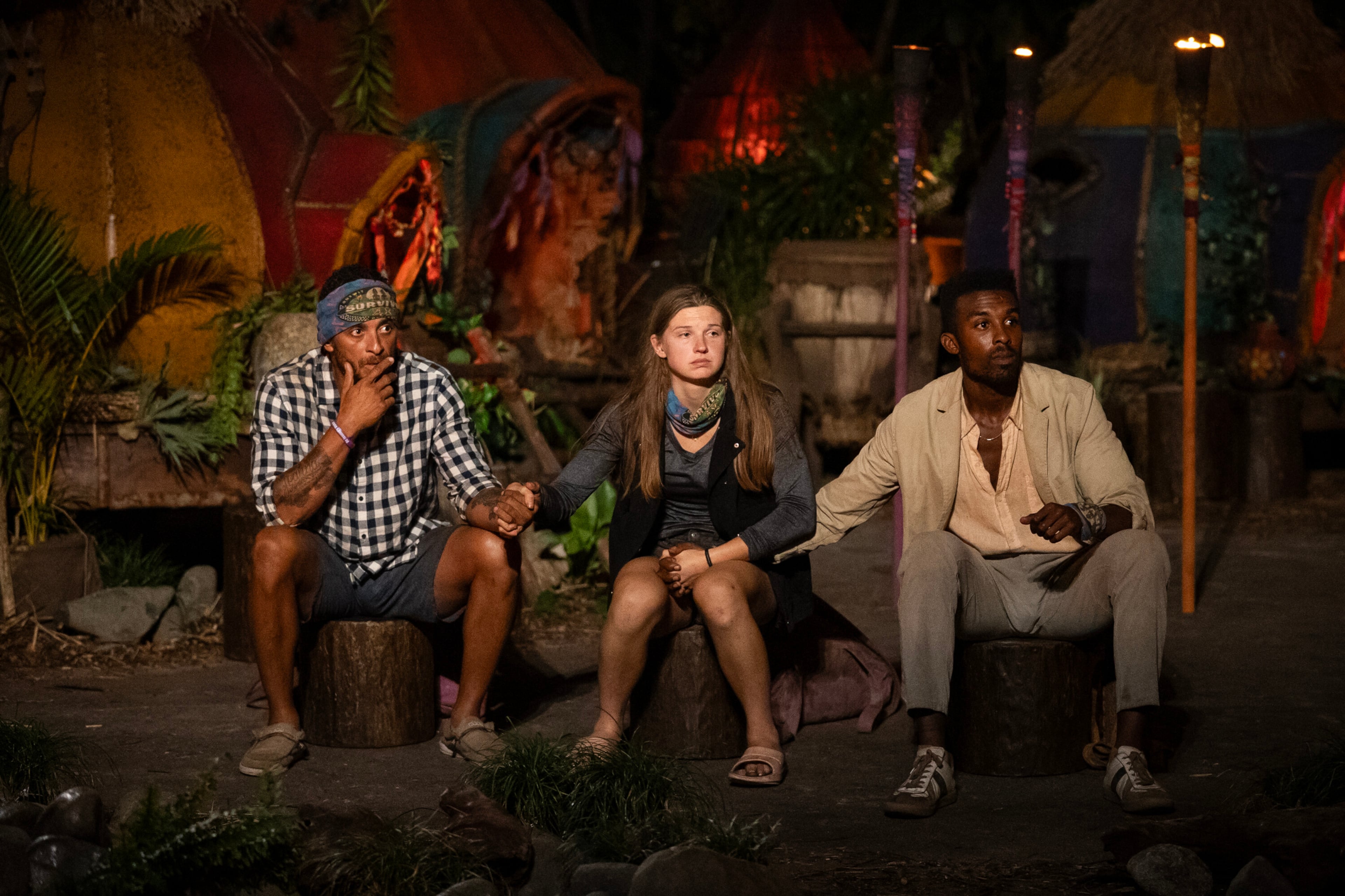 Joe Hunter (from left), Eva Erickson and Kyle Fraser wait to hear their fates during the final tribal council on the "Survivor" finale. (Chuck Snyder/CBS)