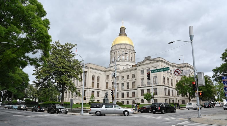 A processional led by hearses from the 9th District of Georgia Funeral Service Practitioners Association circles the state Capitol on Thursday, April 30, 2020, to illustrate what protesters fear will be the deadly consequences of Gov. Brian Kemp’s decision to allow his sheltering-in-place order to expire. (Hyosub Shin / Hyosub.Shin@ajc.com)