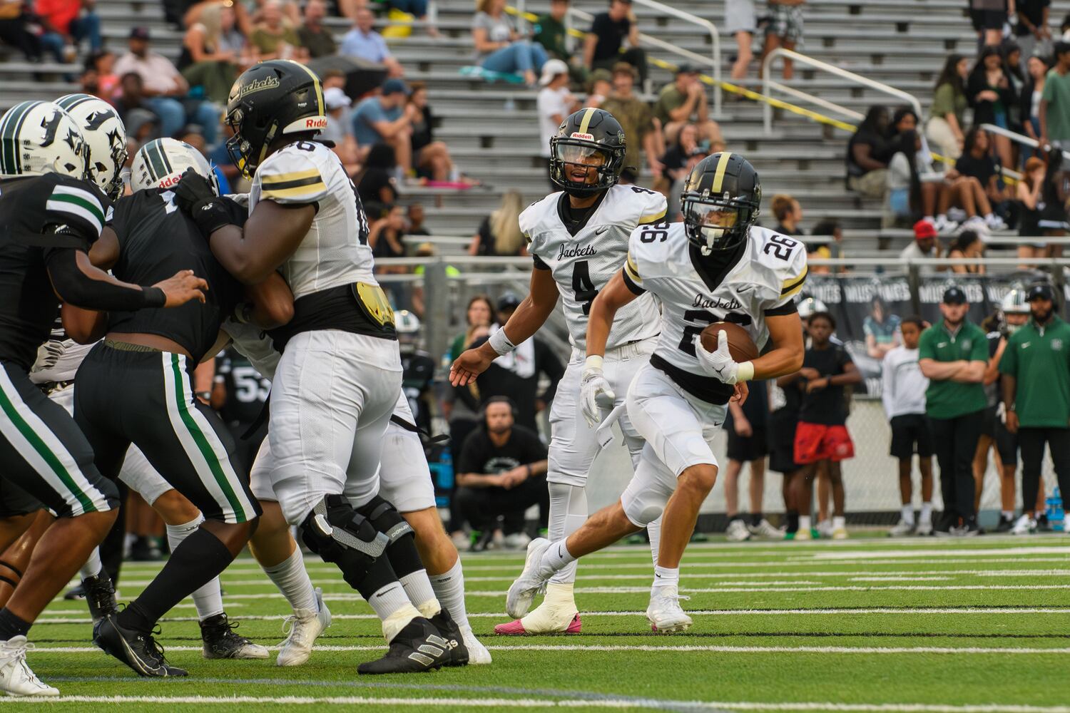 Ian Hulbert, running back for Sprayberry High School, takes a handoff and runs the ball for a touchdown during the Sprayberry at Kennesaw Mountain high school football game in Kennesaw, GA on August 30, 2024. (Jamie Spaar for the Atlanta Journal Constitution)
