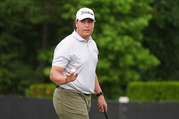 Aldrich Potgieter, of South Africa, waves after his putt on the ninth hole during the first round of the Rocket Classic golf tournament at the Detroit Golf Club, Thursday, June 26, 2025, in Detroit. (AP Photo/Paul Sancya)