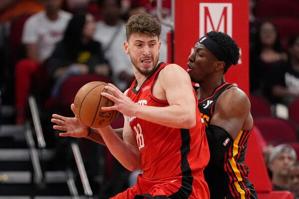 Atlanta Hawks' Onyeka Okongwu, right, defends against Houston Rockets' Alperen Sengun (28) during the first half of an NBA basketball game Tuesday, March 25, 2025, in Houston. (AP Photo/David J. Phillip)