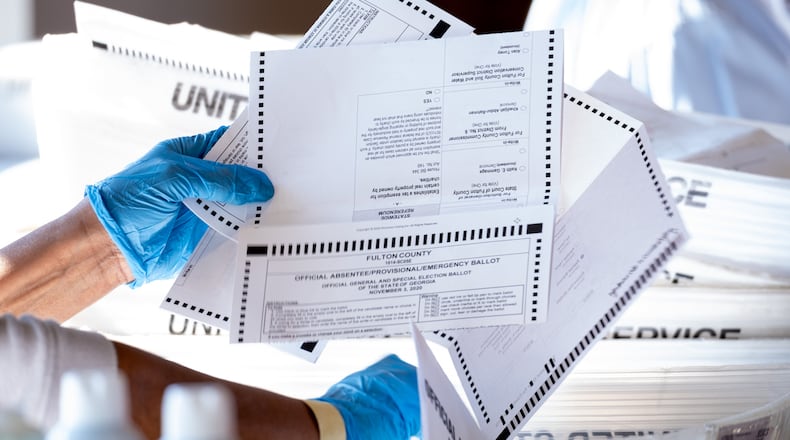 Atlanta-Fulton County elections workers sort absentee ballots at State Farm Arena on Wednesday afternoon, Nov. 4, 2020. Ben Gray for the Atlanta Journal-Constitution