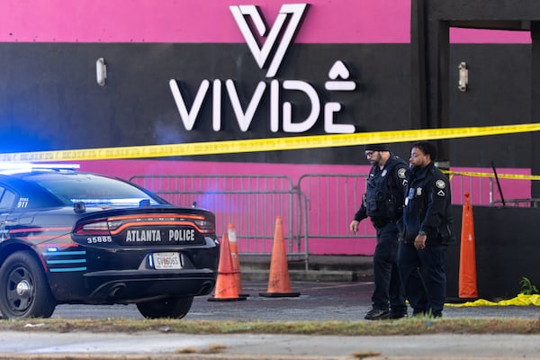 Two Atlanta police officers walk through the parking lot of the Vivide nightclub Wednesday, Nov. 26, 2025. (Ben Hendren for the AJC)