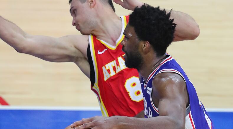Philadelphia 76ers center Joel Embiid slams into Atlanta Hawks forward Danilo Gallinari.   “Curtis Compton / Curtis.Compton@ajc.com”