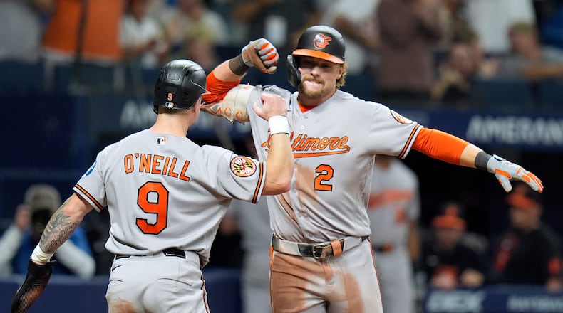 Baltimore Orioles' Gunnar Henderson (2) celebrates his two-run home run off Tampa Bay Rays pitcher Chris Roycroft with Tyler O'Neill (9) during the eighth inning of a baseball game Friday, Aug. 14, 2026, in St. Petersburg, Fla. (AP Photo/Chris O'Meara)