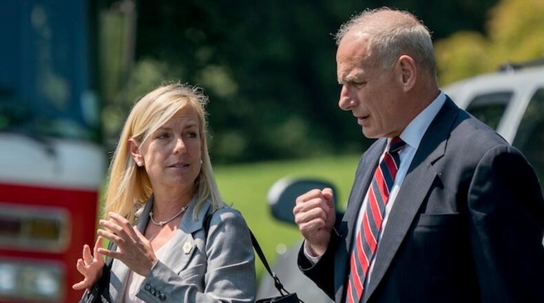 White House Chief of Staff John Kelly and Deputy Chief of Staff Kirstjen Nielsen speak together as they walk across the South Lawn of the White House in Washington, Tuesday, Aug. 22, 2017, to board Marine One with President Donald Trump for a short trip to Andrews Air Force Base, Md. then onto Yuma, Ariz. to visit the U.S. border with Mexico and attend a rally in Phoenix. (AP Photo/Andrew Harnik)