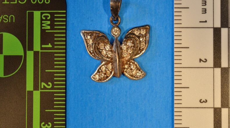 This butterfly charm was found with the remains of a woman's bones in Banks County in February. (Credit: GBI)