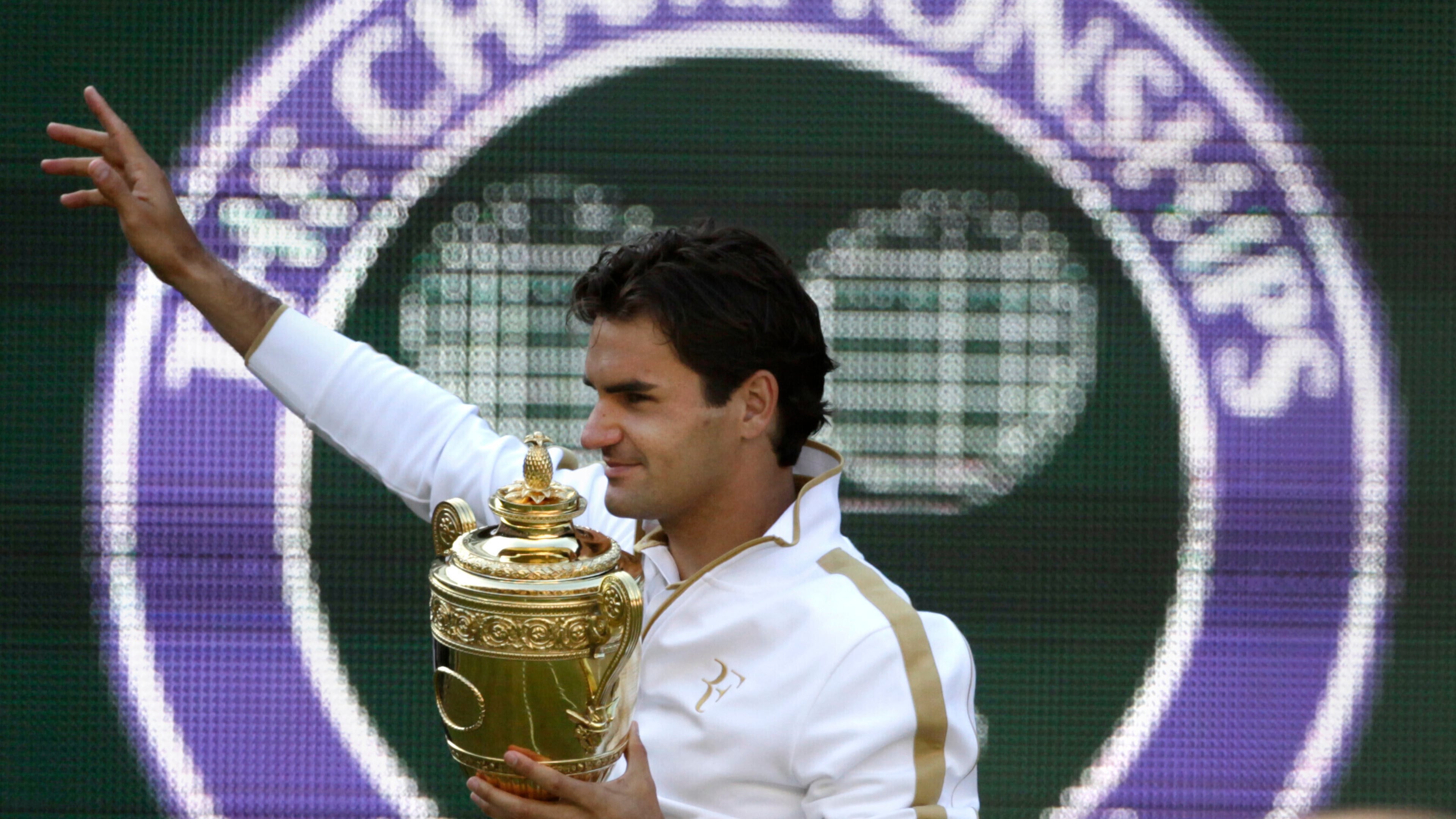 FILE - Roger Federer of Switzerland holds the trophy after defeating Andy Roddick of U.S. in their men's final match on the Centre Court at Wimbledon, July 5, 2009. (AP Photo/Anja Niedringhaus, file)