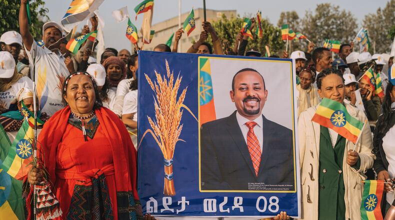 Supporters of Ethiopia's ruling party hold a large portrait of Prime Minister Abiy Ahmed at a rally ahead of the national elections in Addis Ababa, Ethiopia, Tuesday, May 26, 2026. (AP Photo/Amanuel Sileshi)