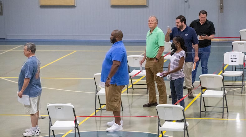 Voters wait in line to vote during an early morning rush at GraceLife Church in Marietta Tuesday morning, May 24, 2022. (Steve Schaefer / steve.schaefer@ajc.com)