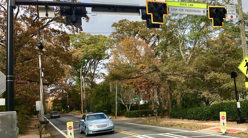 This stretch of Candler Street received a pedestrian-activated beacon several months ago, one of many improvements along the heavily-traveled state road over the last few years. But a collective calling itself “Calm Candler” says it still isn’t enough. Bill Banks file photo for the AJC