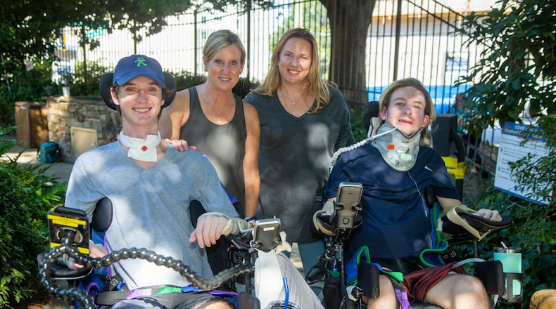 (left to right) Britt O'Brien, his mother Kristen, Jennifer Stanford & her son Julian in The Shepherd Center secret garden. The two mothers met at the center where their boys are patients. Both boys are currently paralyzed due to recent accidents. Due to COVID, the situation has been made extra difficult- no guests, only one parent, etc. The two women met in the halls and have formed an unlikely friendship in the midst of the unfathomable. PHIL SKINNER FOR THE ATLANTA JOURNAL-CONSTITUTION.