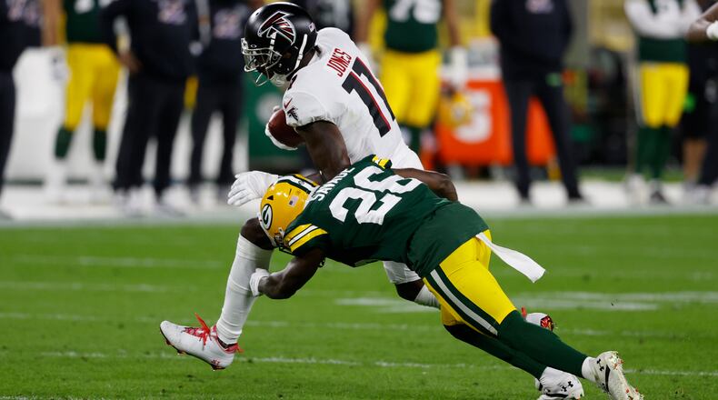 Julio Jones (11) is hit by Packers RB Darnell Savage (26) after a catch in the first half of Monday's Falcons-Packers game.