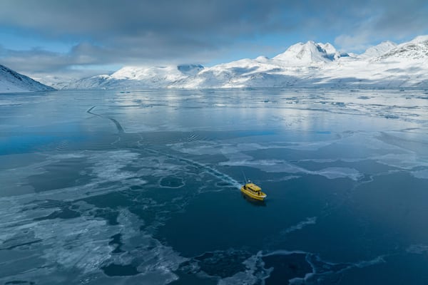 A boat rides through a frozen sea inlet outside of Nuuk, Greenland, March 6, 2025. (AP Photo/Evgeniy Maloletka)
