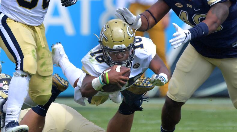 September 23, 2017 Atlanta - Georgia Tech quarterback TaQuon Marshall (16) leaps over Pittsburgh defensive lineman Mike Herndon (66) for yardage in the first half of an NCAA college football game at Bobby Dodd Stadium on Saturday, September 23, 2017. Georgia Tech won 35 - 17 over the Pittsburgh. HYOSUB SHIN / HSHIN@AJC.COM