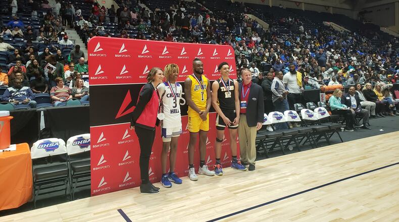 Jeff Davis senior Ja'Queze Kirby (center) with Micah Bell (white jersey) and Alcovy senior Oliver Gerard (black jersey).