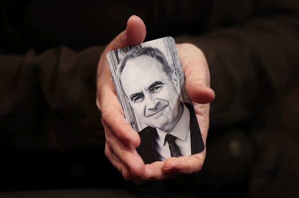Erica Weeder holds a photo of her husband, John Kezdy, in her hands before she goes up to give her impact statement about the two of them being shot by Robert E. Crimo III during his sentencing hearing at the Lake County Courthouse, in Waukegan, Ill., Thursday, April 24, 2025. (Stacey Wescott/Chicago Tribune via AP, Pool)