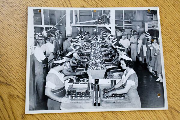 A photograph in the Griffin archives illustrates people working on an assembly line to pack Sunshine Pimiento products. 
(Miguel Martinez/ AJC)